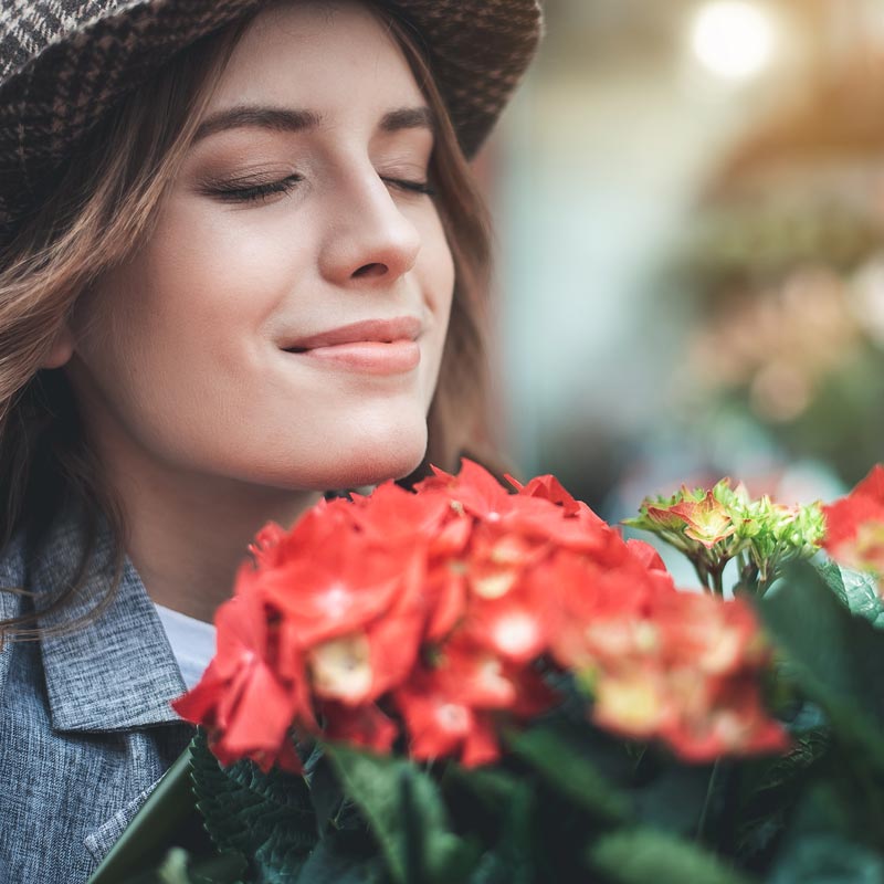 woman smelling flowers
