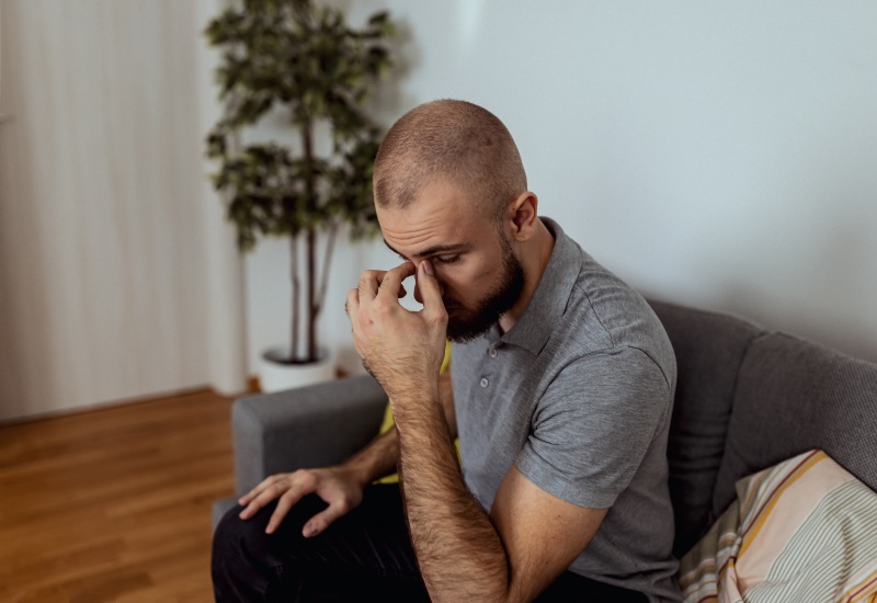A man showing signs of distress due to nasal congestion in St. Peters, MO